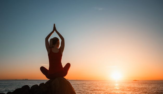 Silhouette,Of,Yoga,Woman,Doing,Meditation,On,The,Sea,Beach